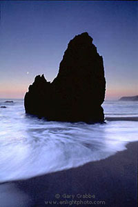 Moonset, surf, and seastack at Rodeo Beach, Marin Headlands, California