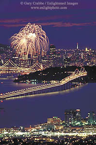 Fireworks explode over San Francisco and the Oakland Bay Bridge, California