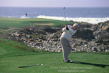 Golfer teeing off on golf course on the Monterey Peninsula, California