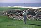 Golfer teeing off on golf course on the Monterey Peninsula, California