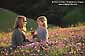 Mother and Daughter in field of wildflowers at sunset, Marin County, California