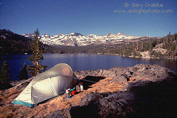 Backpackers wilderness tent camp by moonlight below the Mount Lyell Crest, Eastern Sierra, California