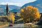 Picture: Red sports car on road in fall below church, near Aspen, Colorado