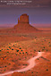 Picture: Dirt road through red desert sands at sunset below butte, Monument Valley, Navajo Nation, Arizona