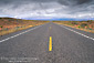 Picture: Storm clouds over empty two lane desert highway, near Lake Powell, Utah