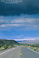 Photo: Storm clouds over two lane desert highway road leading into Death Valley, Death Valley National Park, California