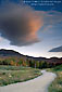Picture: Red light on cloud at sunrise over dirt road, White Mountains, New Hampshire