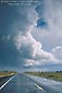 Photo: Thunderstorm cloud over rain covered asphalt road through the high desert, Coconino Plateau, Arizona