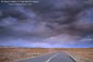Picture: Evening storm clouds over empty desert road, near Goblin Valley State Park, Utah