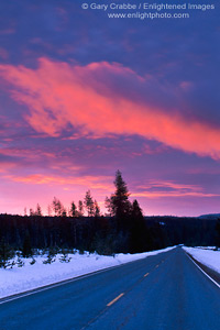 Image: Red cloud at sunrise over straight two lane road in winter, Siskiyou County, Northern California