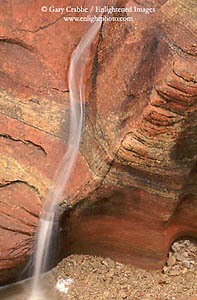 Water from fall rain storm washes over sandstone, Zion National Park, Utah