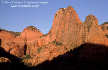 Sunset on sheer red rock cliffs of Kolob Canyon, Zion National Park, Utah