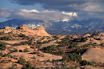 Fall snow storm on La Sal Mountains above the petrified sand dunes of Arches National Park, Utah