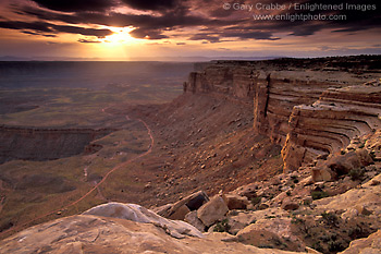 Picture: Stormy sunset over dirt road from atop a high desert mesa, Muley Point Overlook, Glen Canyon NRA, Utah