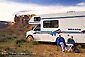 Picture: Couple relaxing outside next to recreational Vehicle RV camper, Valley of the Gods, Utah