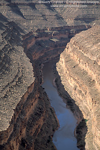 Picture: Looking down into the steep eroded rock wall canyon of the San Juan River, Goosenecks State Park, Utah