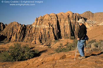 Image: Hiker overlooking red sandstone cliffs at Snow Canyon State Park, near St. George, Utah's Dixie, Utah