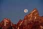 Full moon sets over the Grand Teton at sunrise, Grand Teton National Park, Wyoming