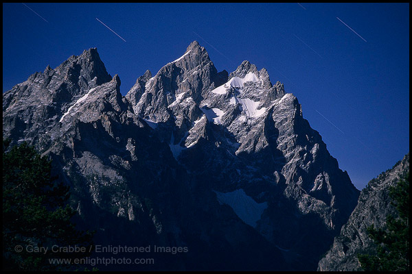 Star streaks at night over the Grand Tetons by light of full moon, Grand Teton National Park, Wyoming