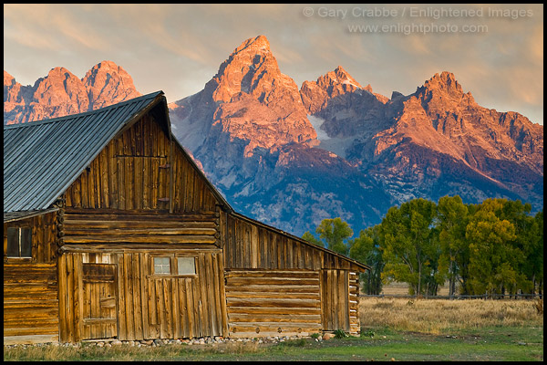 Sunrise light on the Grand teton mountain peak over old wooden barn, Grand Teton National Park, Wyoming