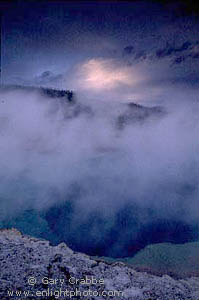 Stormy sunset at Sapphire Pool, Biscuit Basin Geyser Area, Yellowstone National Park, Wyoming